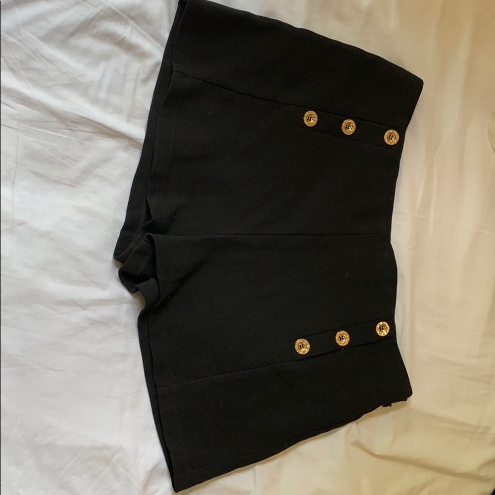 Women’s black shorts with gold buttons